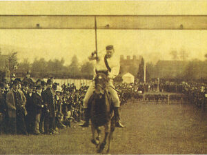 Man riding horse whilst holding ple used for competition.