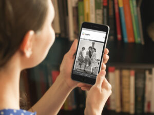 Woman looks at Inspire Picture Archive on mobile phone.